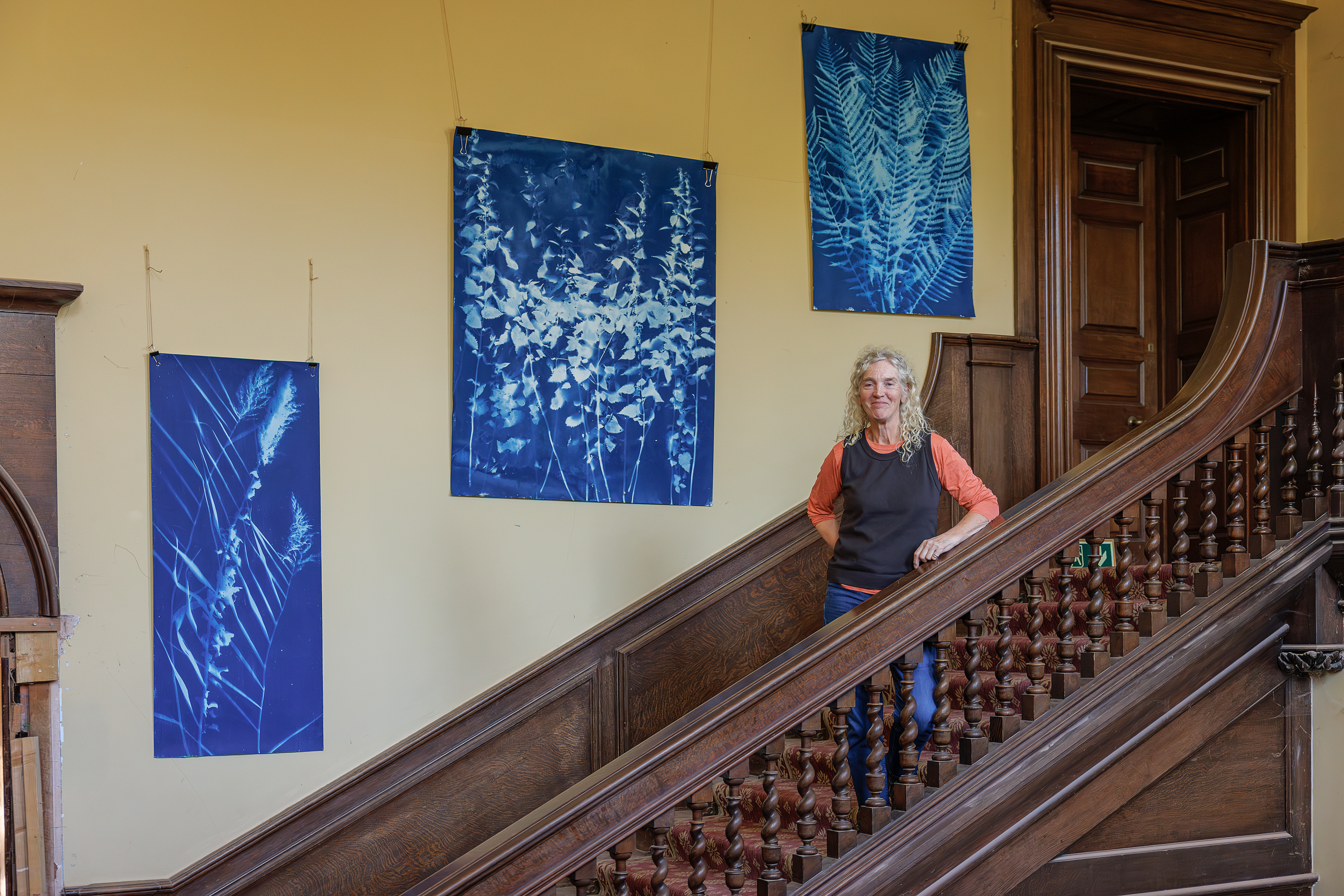 Me, alongside three cyanotypes on display in Haswell House, 2025
